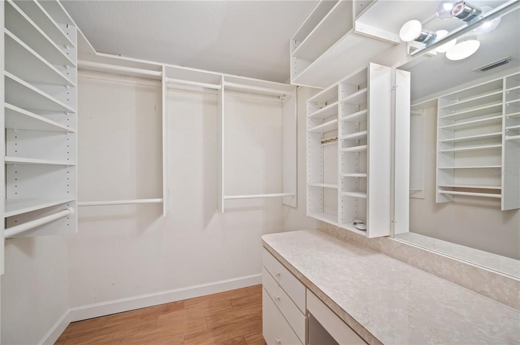 Walk in Closet 1 of 2 with a dressing table and mirror in the Master Suite.