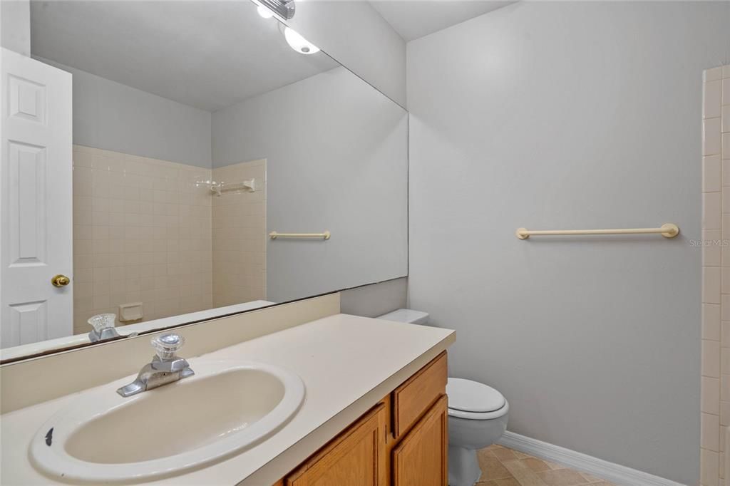 View into guest bath on first floor that features a bath tub/shower.