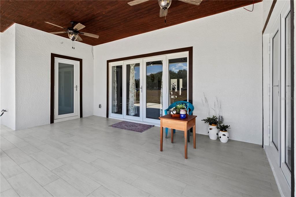 Covered back patio and entrance to half bath