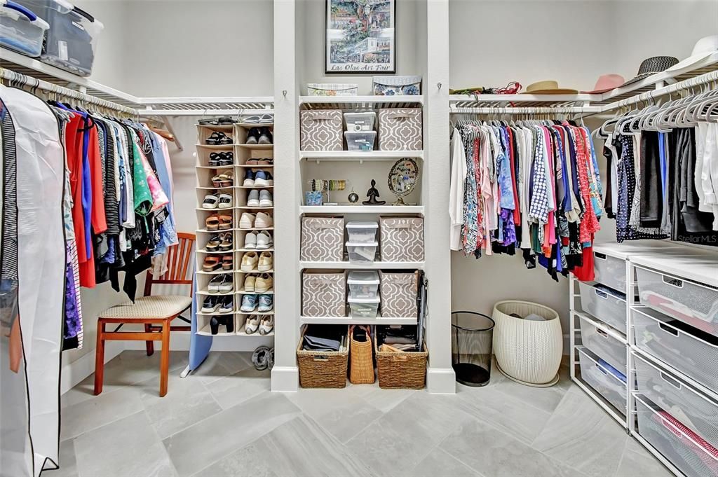 Spacious walk in closet with wood shelves
