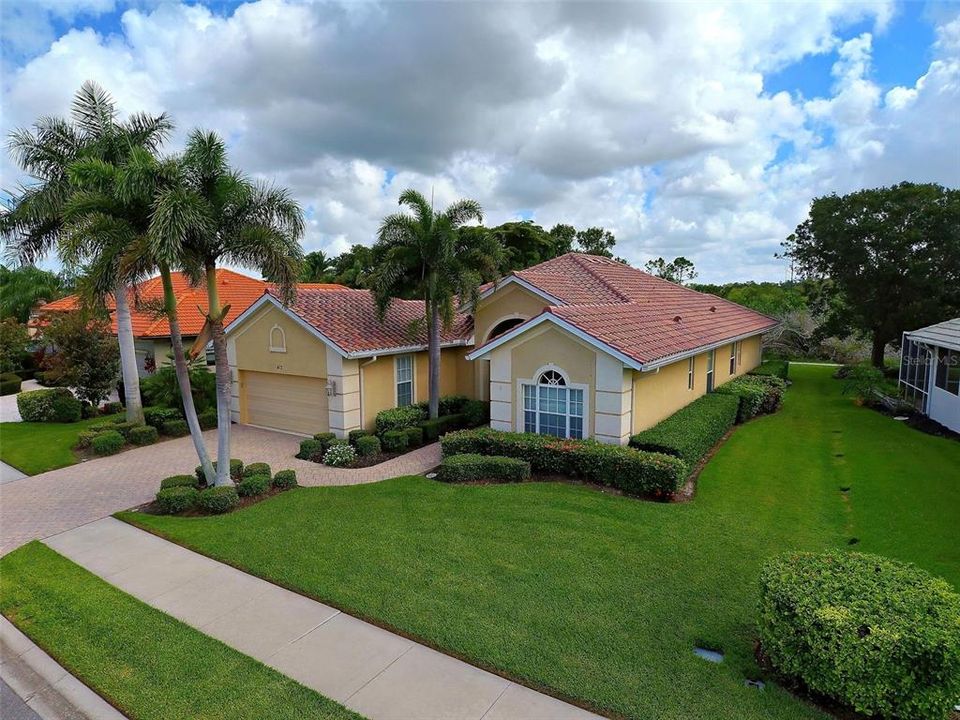 Home has beautiful curb appeal with its lush, tropical landscaping and is on a large lot.