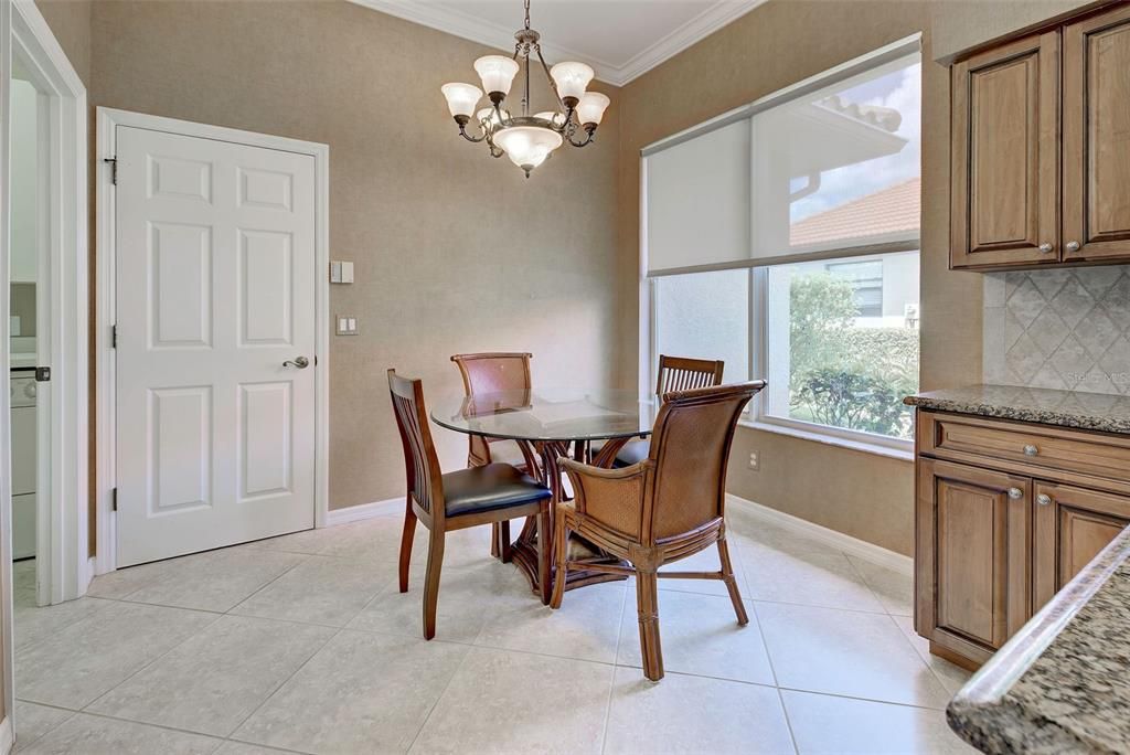 Another view of breakfast nook with interior laundry room to the left and convenient door to the garage.