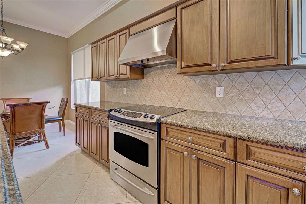 Gorgeous kitchen offers solid wood, custom cabinets, gleaming granite countertops and stainless-steel appliances.