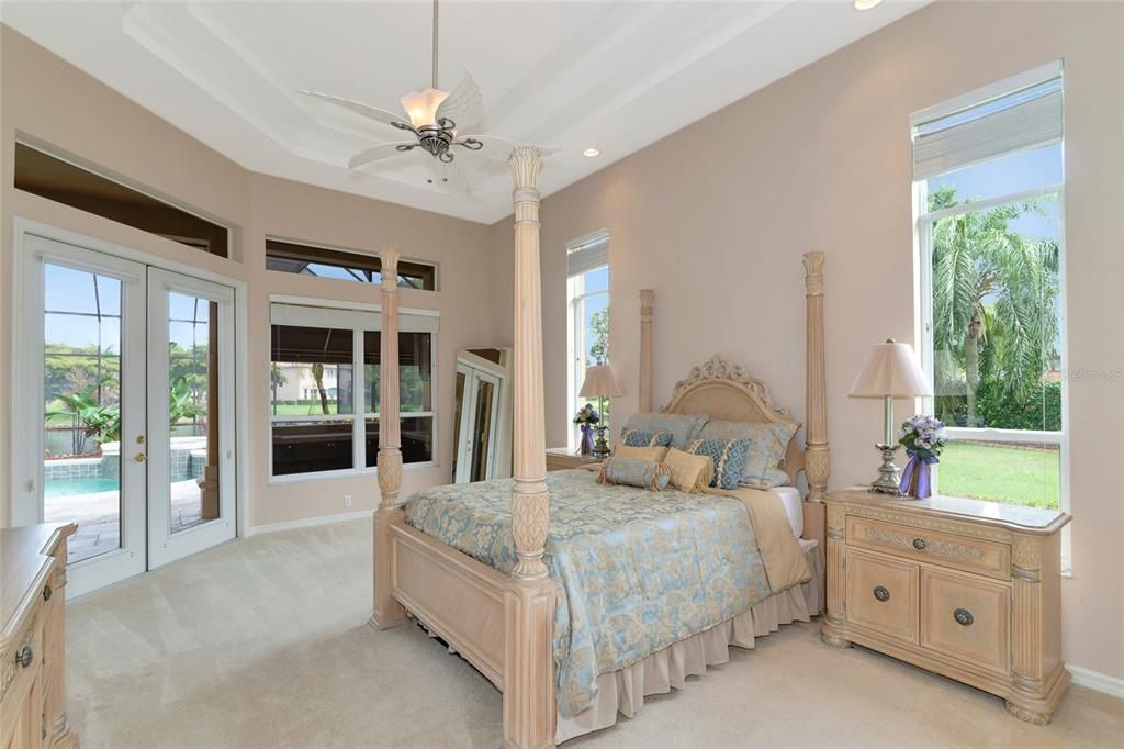 Primary bedroom overlooking pool and lake.