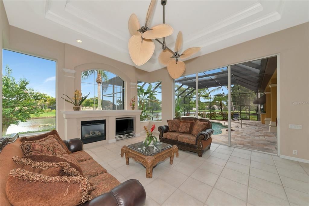 Family room overlooking the pool and lake with plenty of natural light.