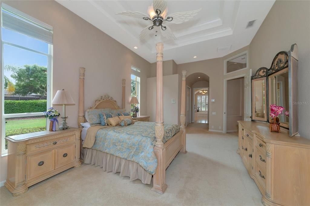 Primary bedroom overlooking pool and lake.