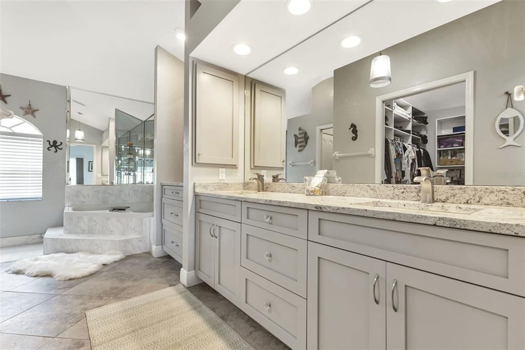 Master bathroom features dual sinks with granite countertop.