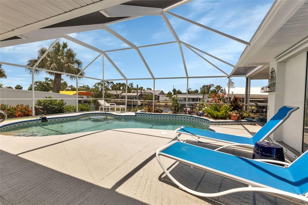 Welcome to your backyard oasis, perfect place to sunbath or relax in the solar heated saltwater pool.