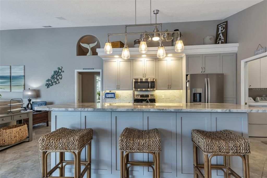 Stainless steel appliances, beautiful light fixtures and ample amount of cabinets and counter space.