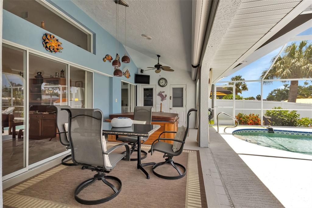 Covered lanai features electric roll down hurricane shutters, half bath and a storage closet.