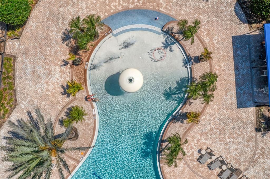 Zero-depth beach entry and splash pad at the community pool