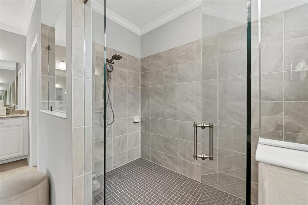 Frameless custom shower gives a larger spacious feel