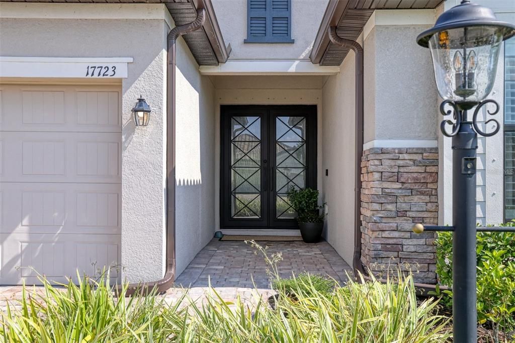 Welcoming entrance with gutters and stone accent