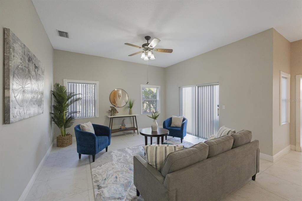 Family room looking out the windows into the backyard and through the sliding glass door.