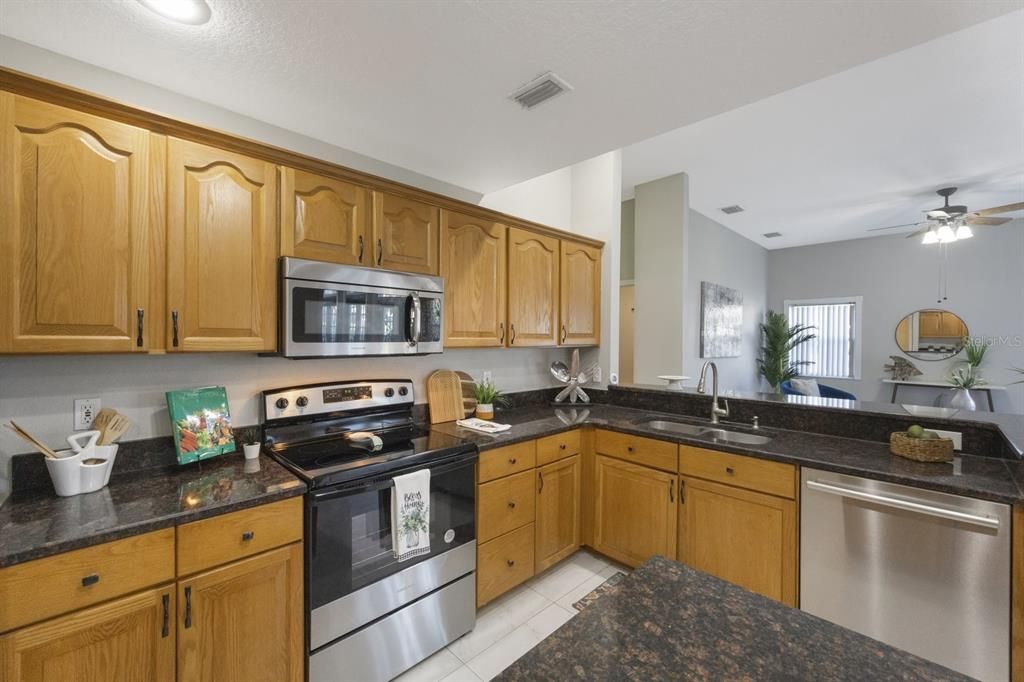 Granite countertops including an overhang that offers additional seating.