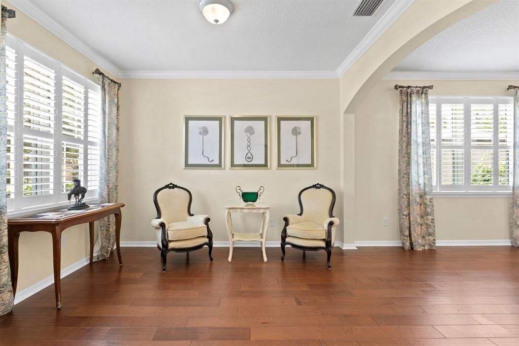 Graceful arches open to the formal living room