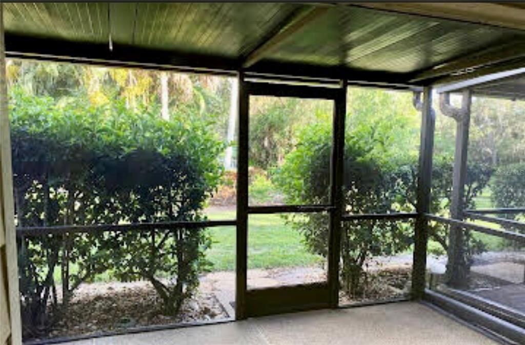 Screened porch with view of pool