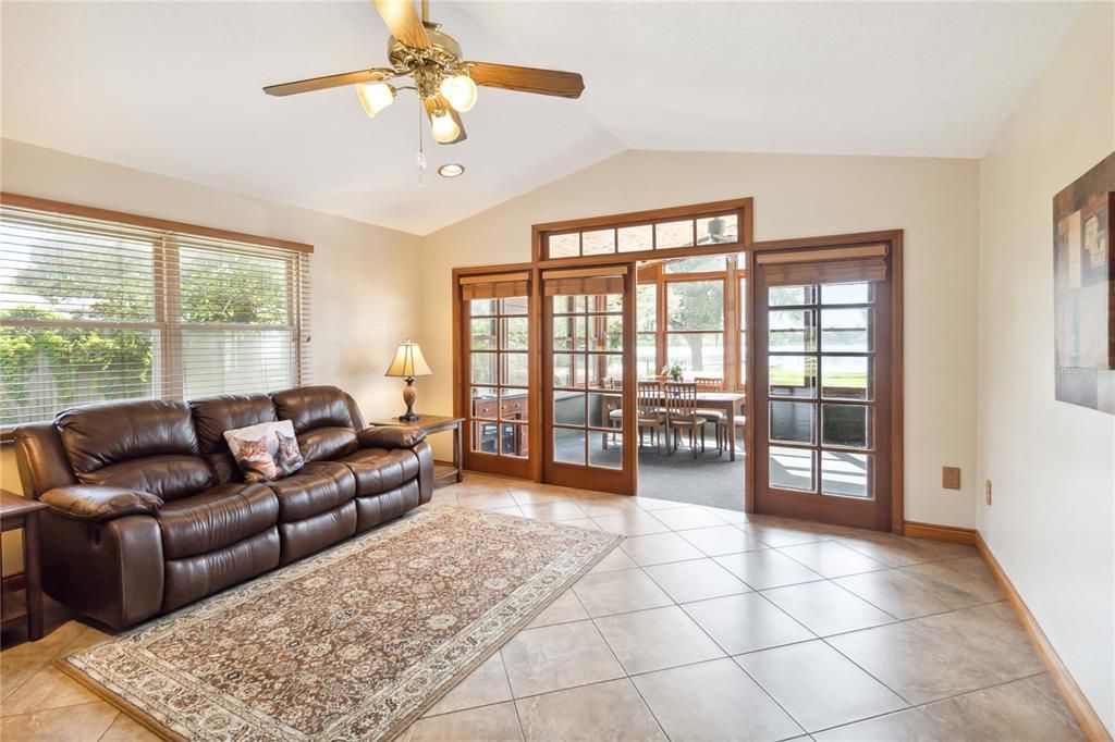 Open Family Room with tile floors and French Doors to the Florida Room