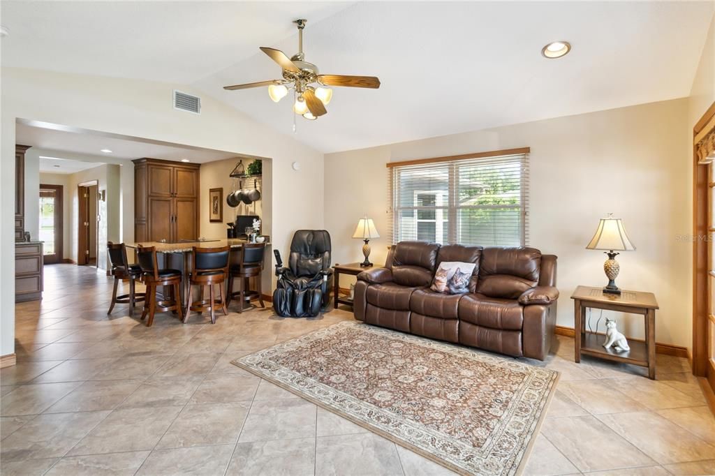 Open Family Room with tile floors and cathedral ceiling