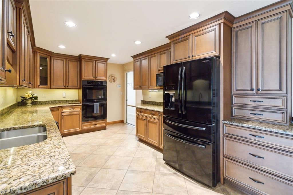 Kitchen view with grantie counters and access to the inside laundry room