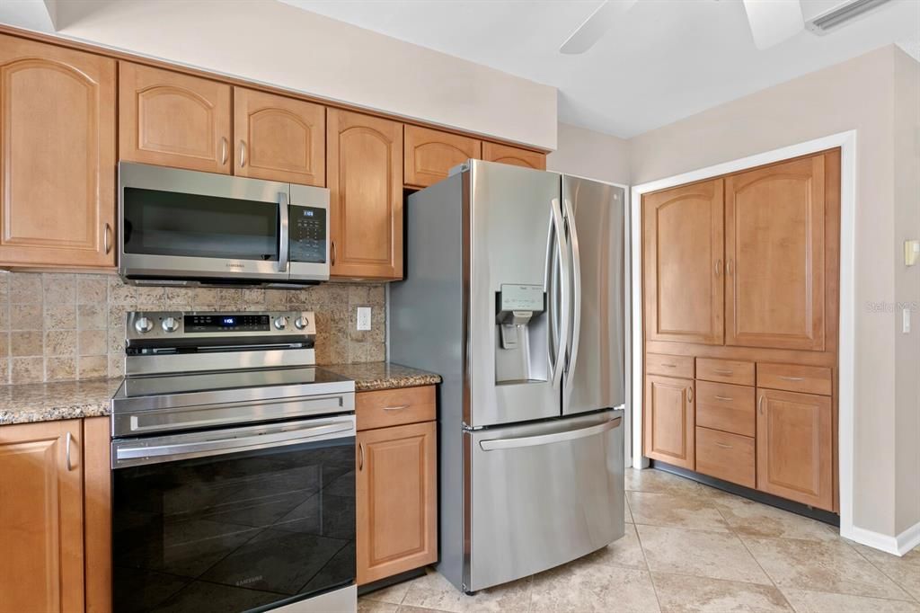 Custom cabinets for the closet pantry provide additional storage