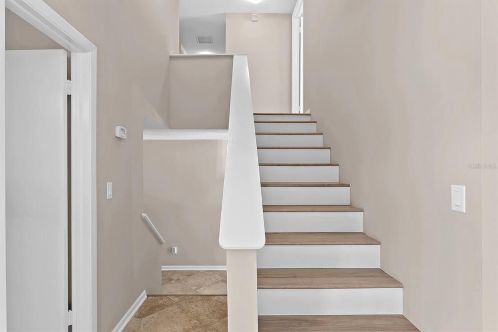Split staircase leading up to the 2nd floor and all 4 bedrooms - all with Brand New LVT floors