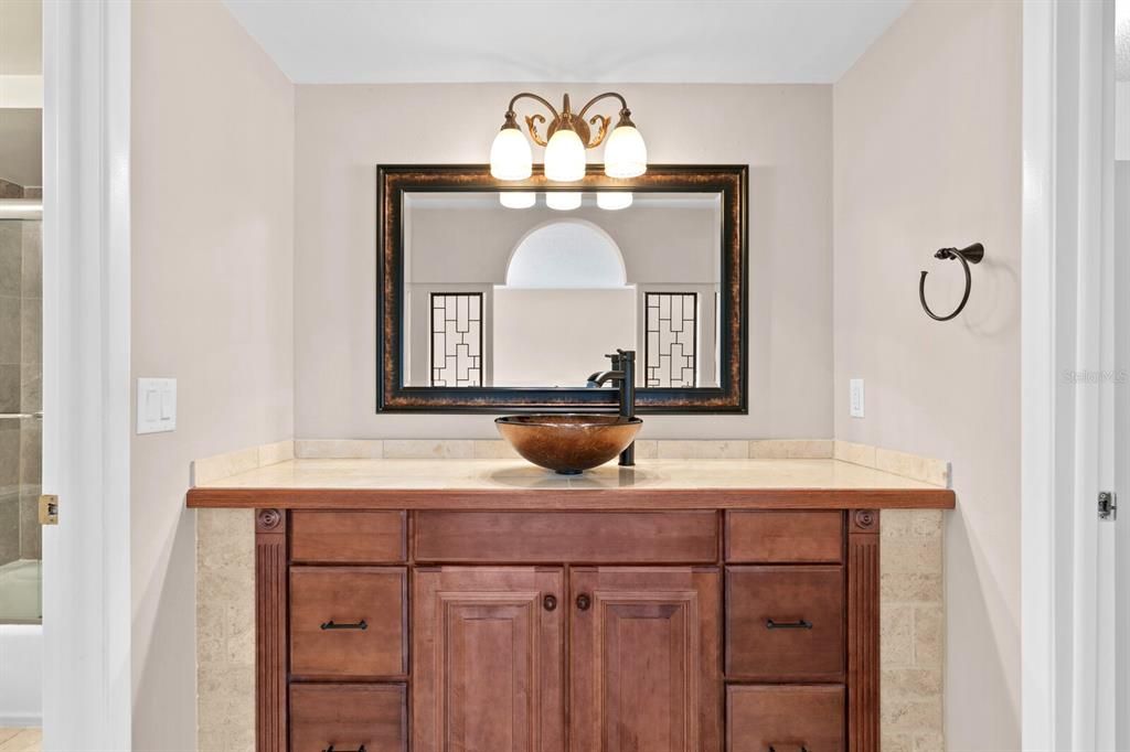 Primary bath features an updated vanity and vessel sink