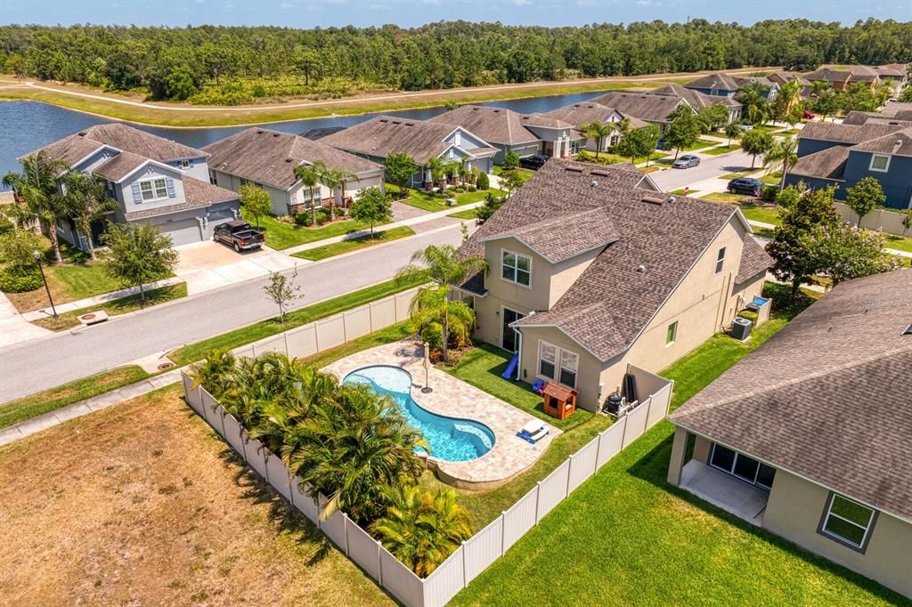 Views of the back of the home and fully-fenced backyard