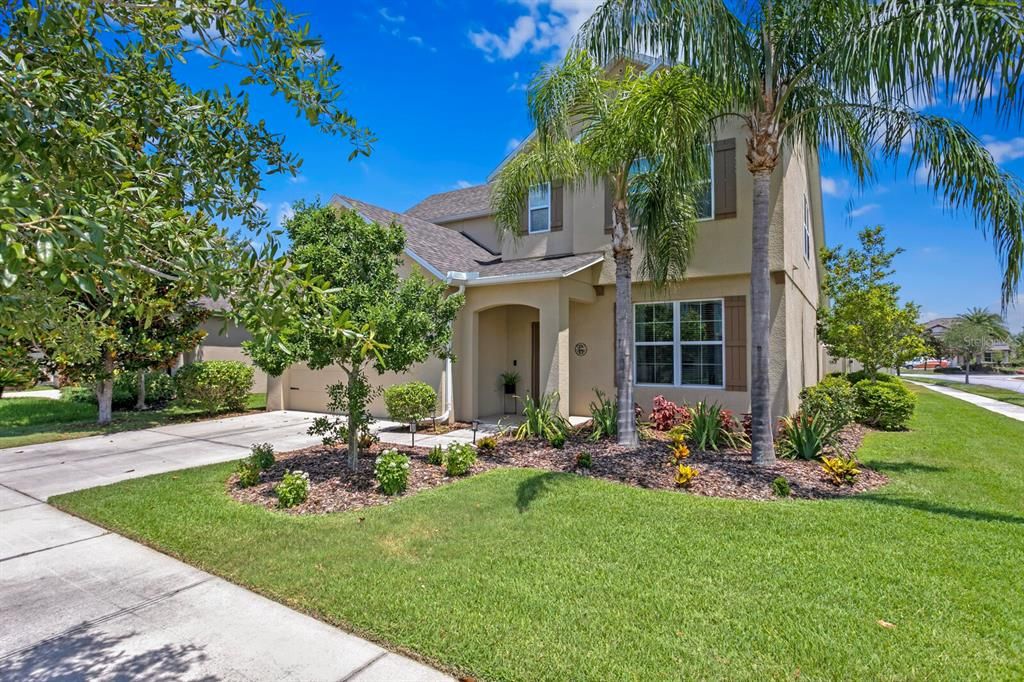 Large corner lot with a thick, green lawn