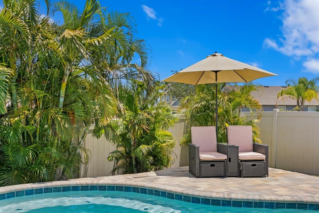 Relax under the umbrella next to your private pool