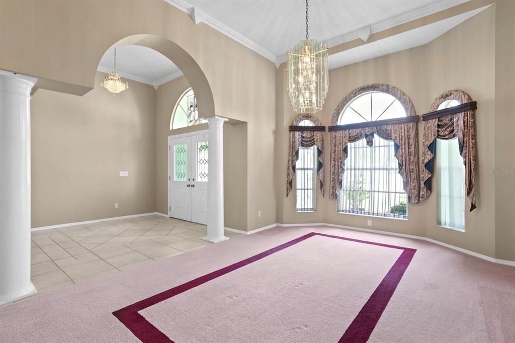 Spacious formal dining room with bay windows and 12ft ceilings