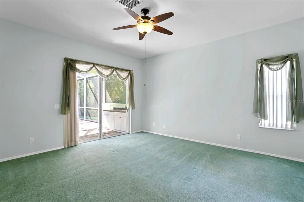 Primary suite with ceiling fan and tons of natural light