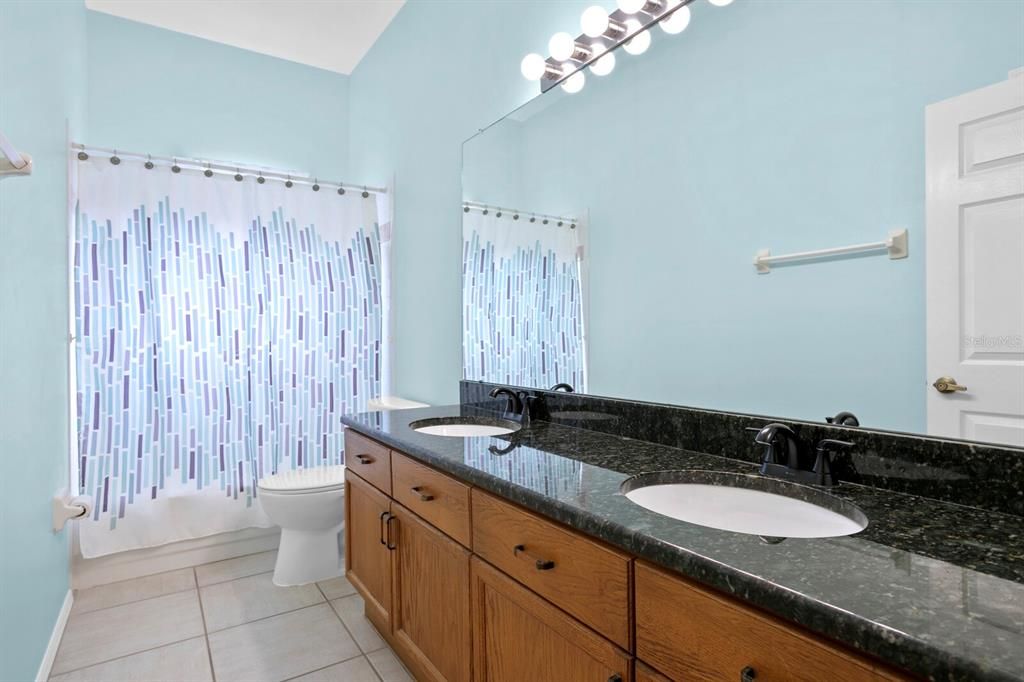 The 2nd full bath has granite counters, double sinks and a tub/shower combo