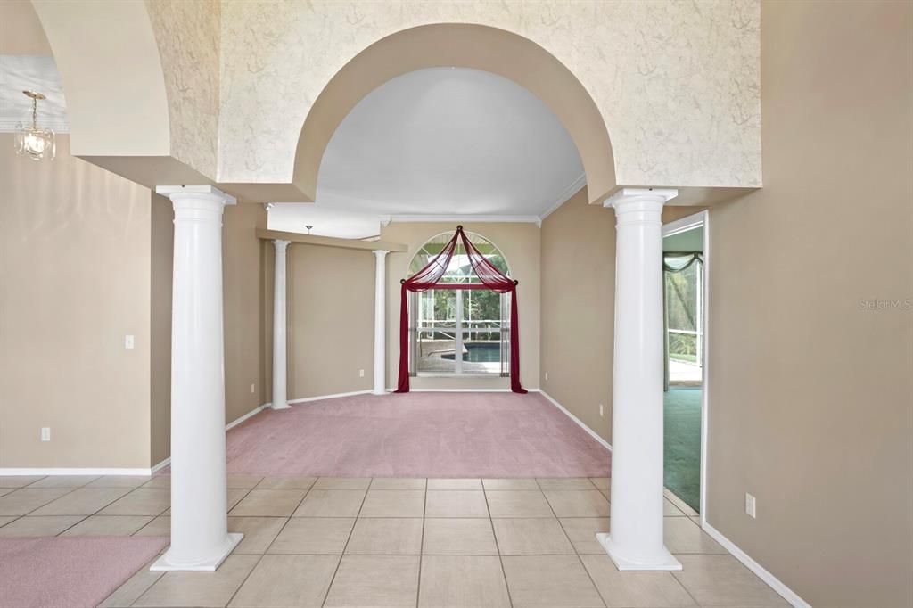 Views from the foyer looking towards the formal living room and primary suite on the right