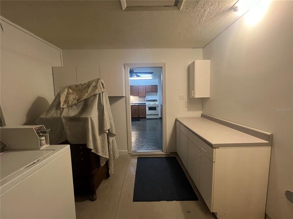 Back to Side entry door in Laundry/Utility room looking into kitchen