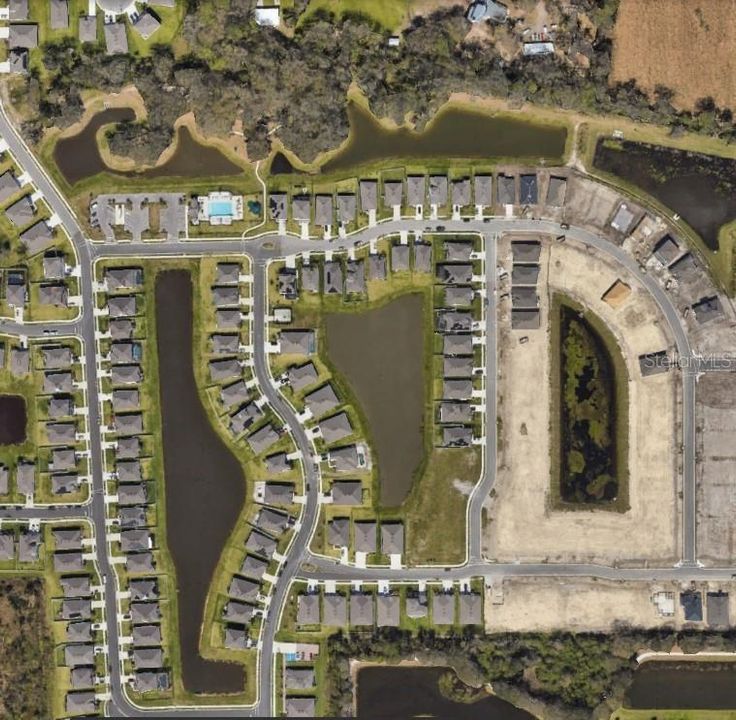 Aerial View of Land Parcel and surrounding home sites within community