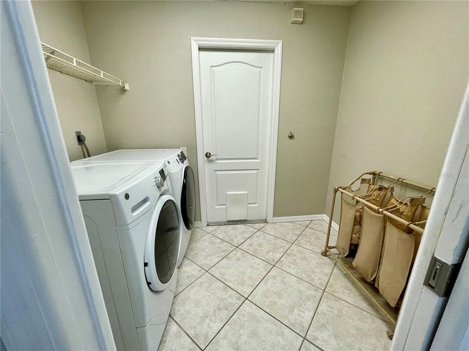 Spacious laundry room is off the kitchen.