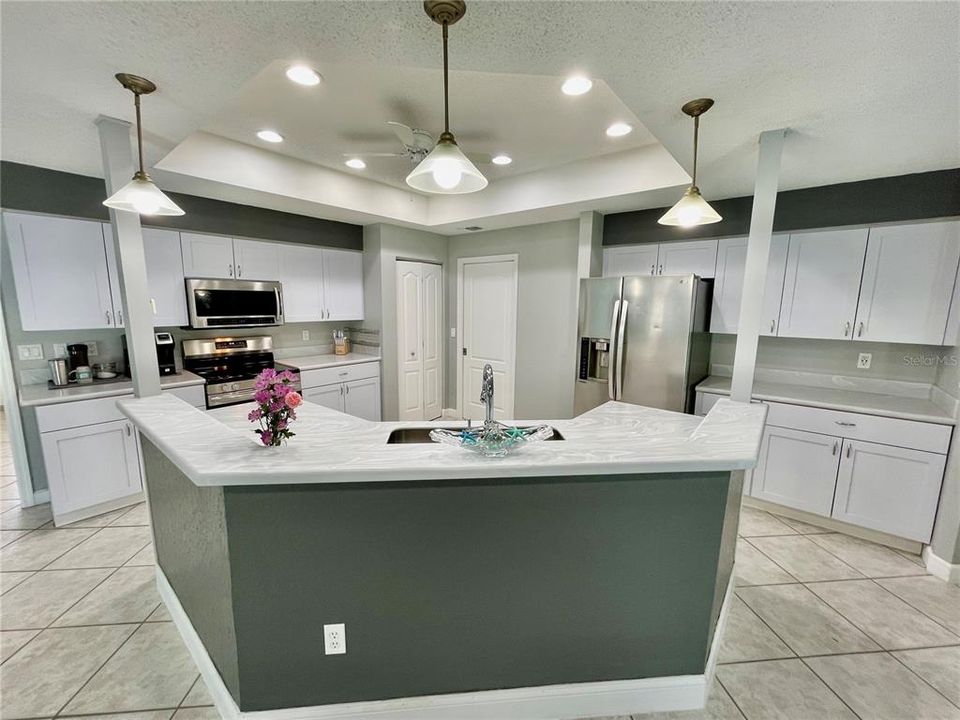 Kitchen was remodeled with white cabinets and Corian counter tops