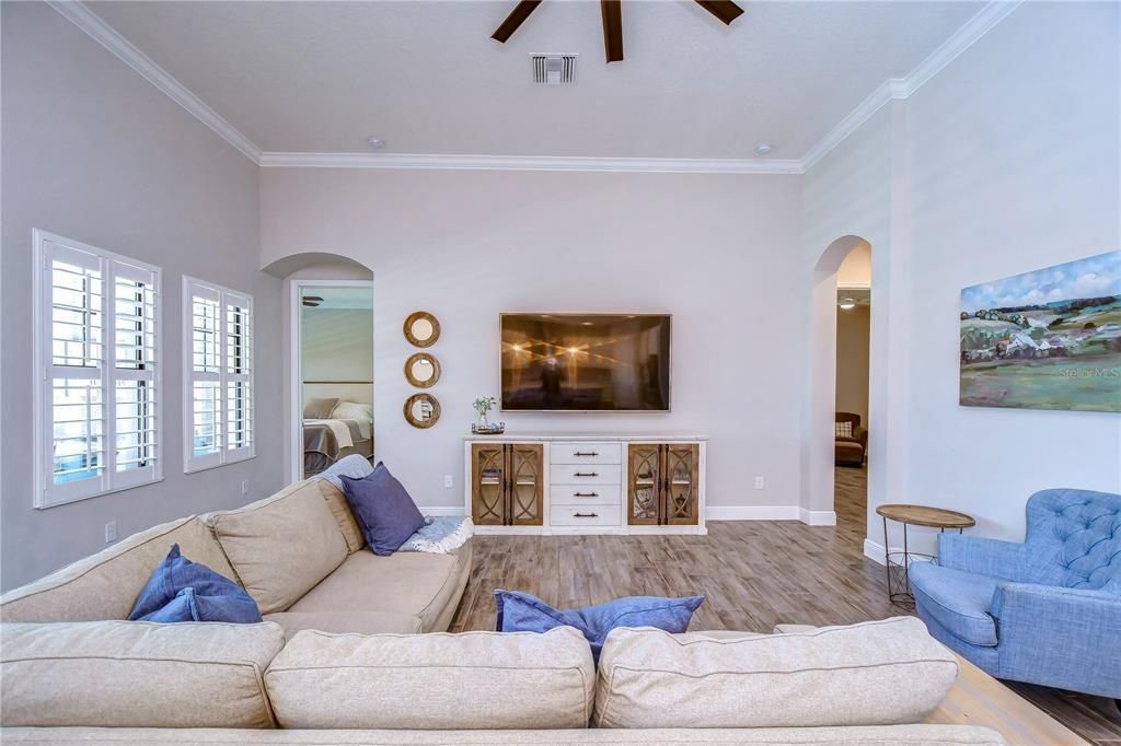 Great room with crown & plantation shutters!