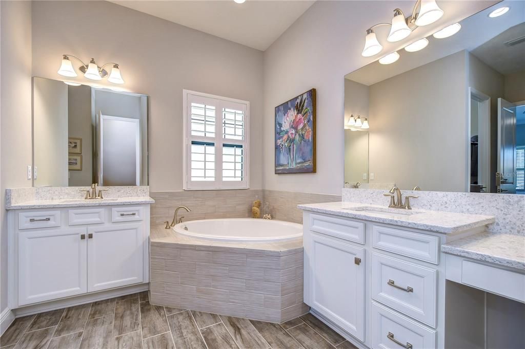 Primary bath with his & hers vanities & soaking tub!