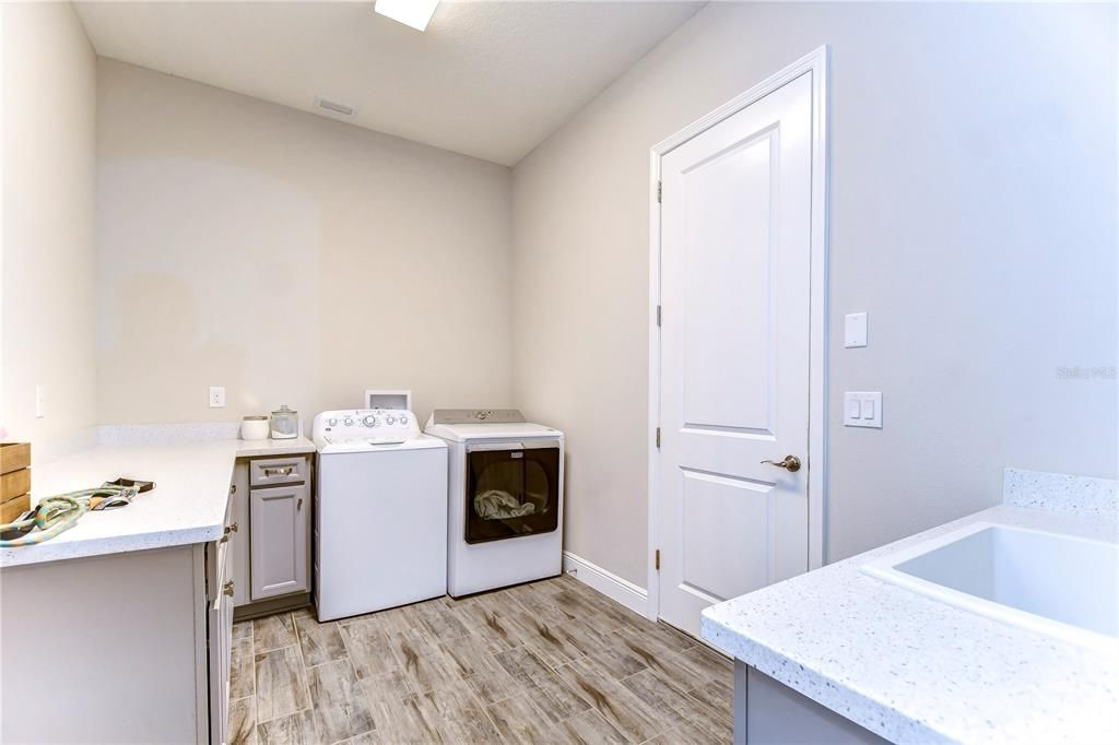 Laundry room with cabinets & sink!