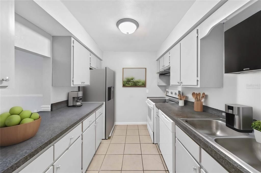 Virtually staged items in large kitchen with open view view of living room