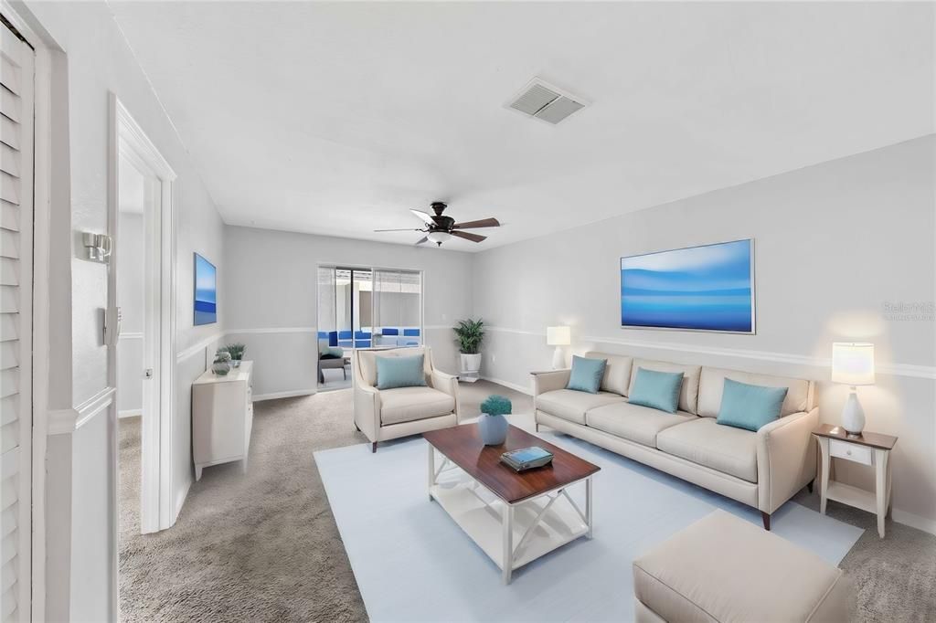 Virtually staged large living room with balcony and view of kitchen