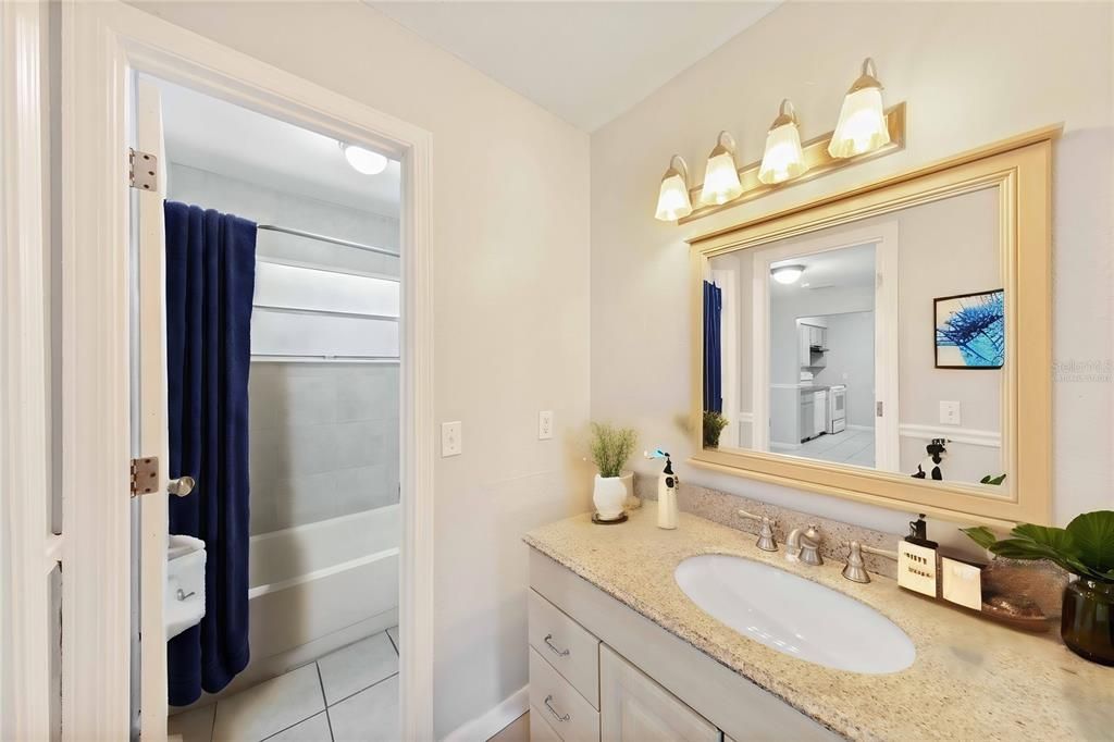 Virtually staged items in large bathroom with separate quarters for shower/tub combo and toilet