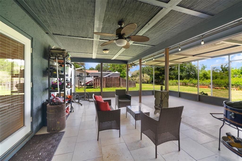 The extended screened lanai has all the outdoor space you could ask for overlooking a yard big enough to add a pool!