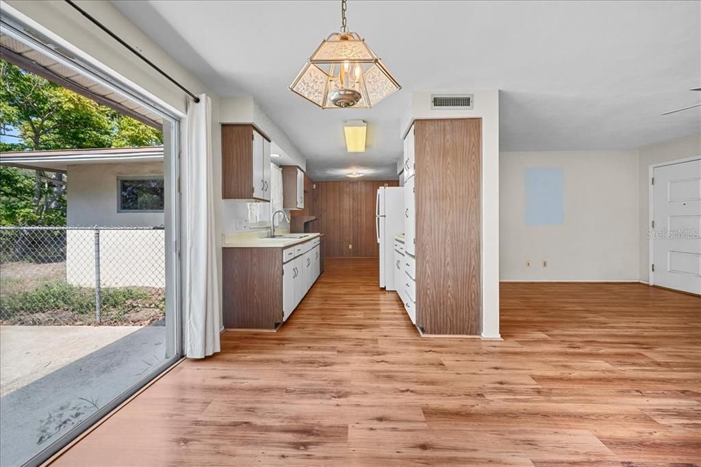 Kitchen and dining area with back patio access.