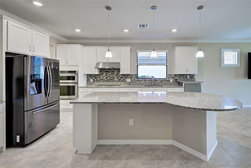 The oversized kitchen island can accommodate up to six stools.  You can talk to your guests while you cook an amazing dinner.