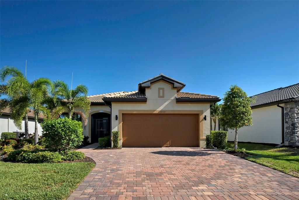 This home has curb appeal!  Beautiful paved driveway, manicured landscaping and tile roof.