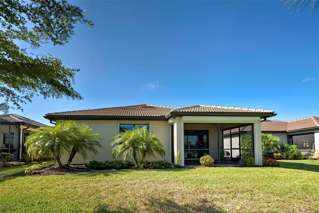 A view of the back of the home with landscaping.