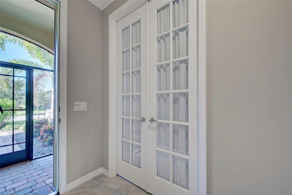 The front porch is screened and there are glass double doors to the flex room on your left as you walk into the home.